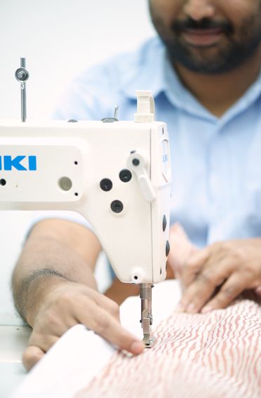 Machinist stitching a curtain hem in the workshop
