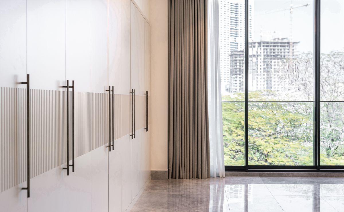 Sheer curtains beside fitted wardrobes with a view over Dubai